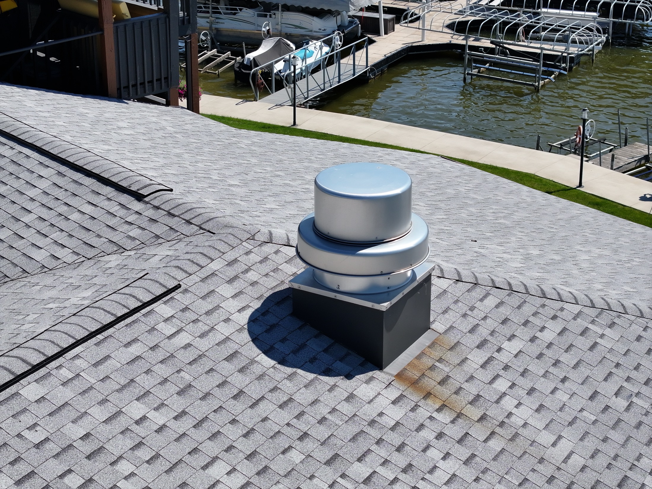 Roof cap and stained shingles near a penetration at 102 Clarendon Drive
